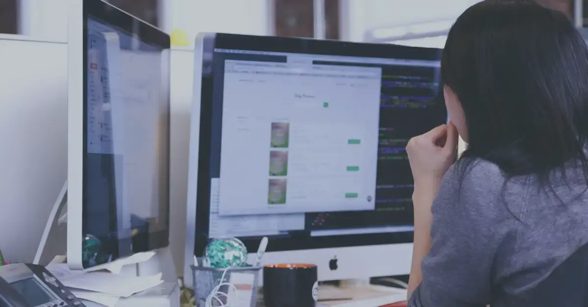 A woman with black hair works on her computer