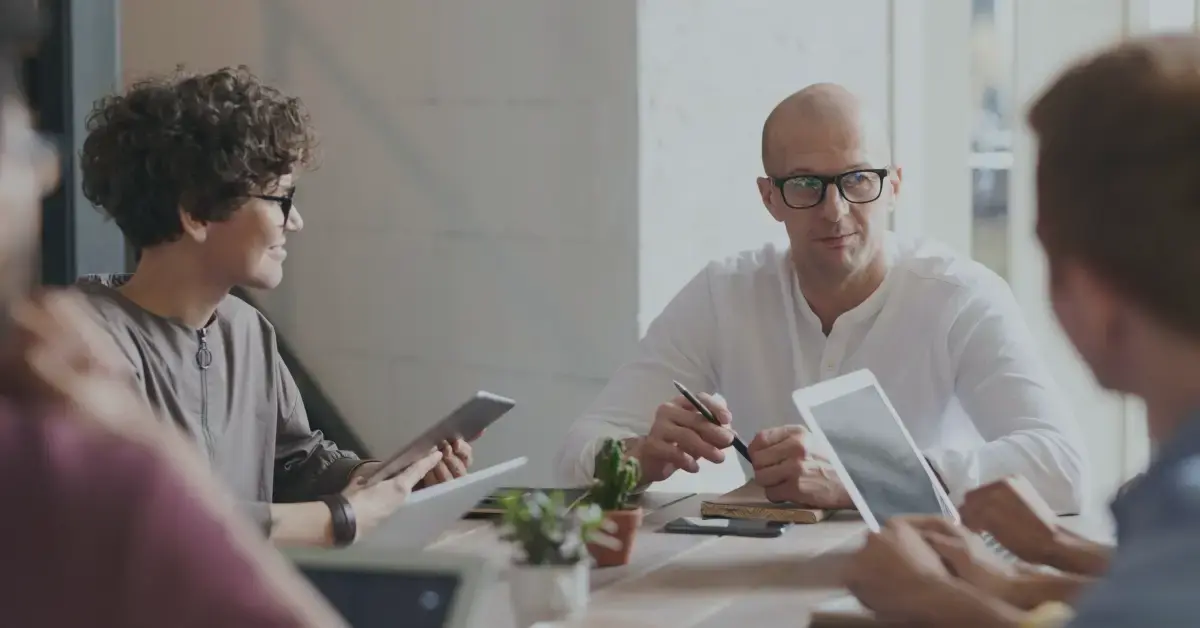 3 people around a table working together